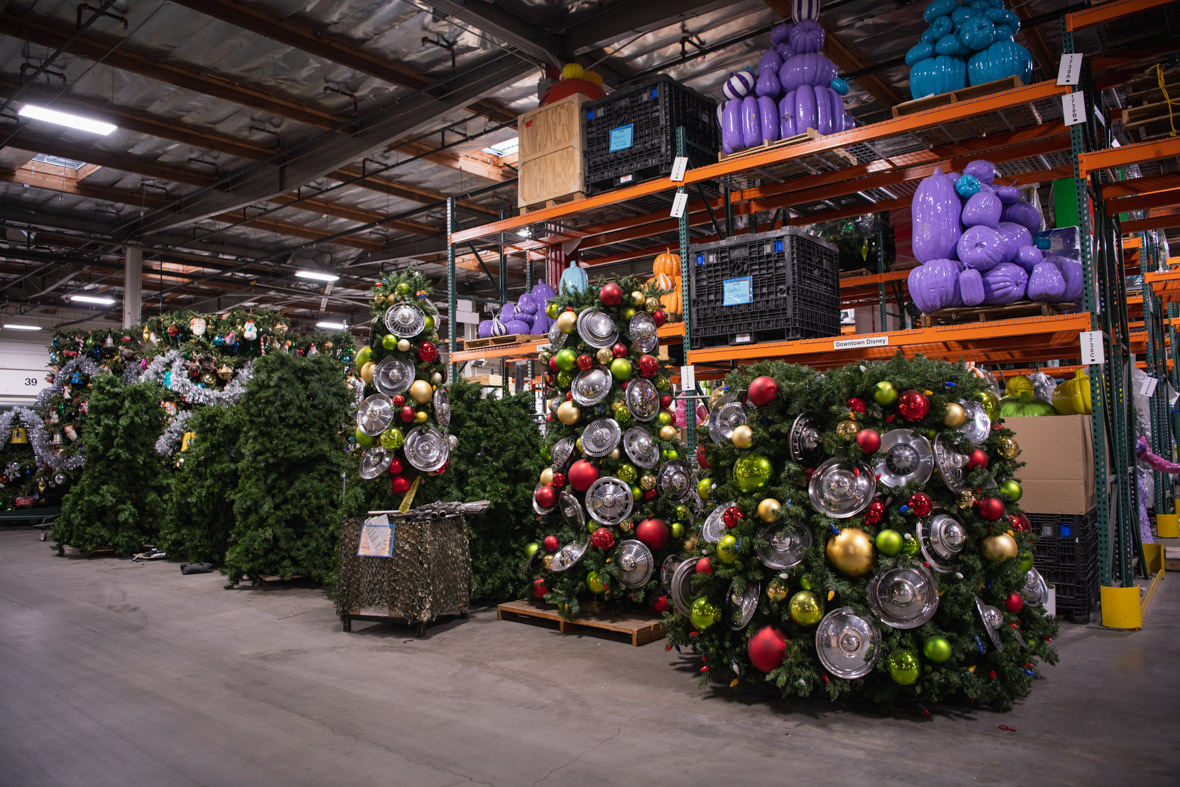 The Cars Land Christmas tree is stored in three pieces in the Resort Enhancement warehouse in Anaheim, California. The ornaments are all hubcaps, and the tree topper, sitting on the floor, is a star made out of tailpipes.