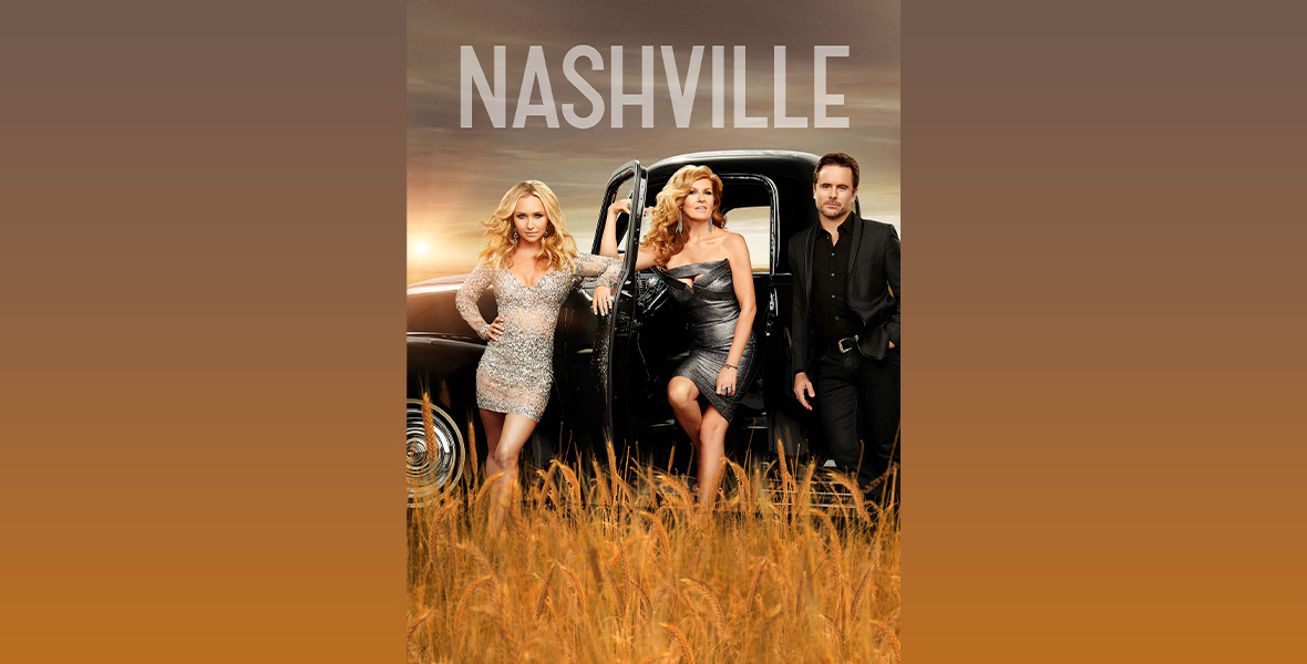 Key art for the ABC’s drama series Nashville. Actors Hayden Panettiere, Connie Britton, and Charles Esten stand in a corn field next to a vintage black truck. Panettiere stands with her right arm on her right hip and left arm on the car. Panettiere wears a silver, sequined mini dress with large silver earrings. Britton leans her body into the open cab of the truck. Britton wears a strapless black, sparkly mini dress. Esten wears a black button-down dress shirt and black slacks. Above the truck reads, “NASHVILLE,” in white lettering.