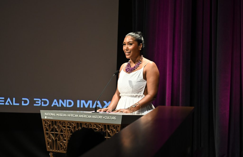 WASHINGTON, DC - OCTOBER 30:  Taylor Simone Ledward speaks on stage during the Black Panther: Wakanda Forever Red Carpet Screening at the Smithsonian National Museum of African American History and Culture on October 30, 2022 in Washington, DC. (Photo by Shannon Finney/Getty Images for Disney)