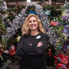 Dawn Pipal-Keehne, Resort Enhancement Area Manager for Disneyland Resort, stands among a bounty of Christmas decorations in the Resort Enhancement warehouse in Anaheim, California.