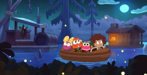 An animated young girl sits in the front row of a brown boat next to a hot pink frog. Behind them are an orange frog with gray hair and a pink frog wearing a yellow polka dot bow. The orange frog holds a wooden treasure chest close to its chest. Around the boat is another boat and a floating wooden cabin. Fireflies are scattered around them.