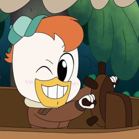 In a still from the animated series Chibi Tiny Tales, Launchpad McQuack, an animated duck from the series DuckTales, steers a small riverboat and winks his right eye. He wears a small green baseball cap on his head and a brown jacket. He has orange hair and white feathers. Behind him are lush green foliage. The boat has a tan canopy and is constructed with brown wood.