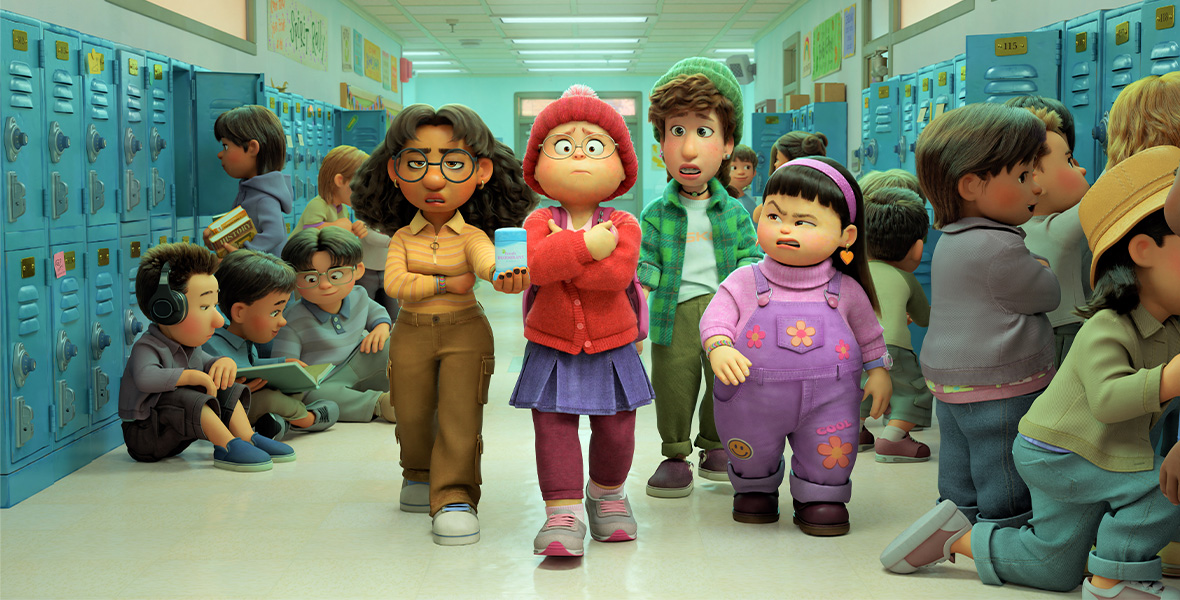 Mei-Mei and her friends walk down the school hallway in Turning Red. Mei is wearing a red sweater, a purple skirt, and purple leggings whole holding onto her books.