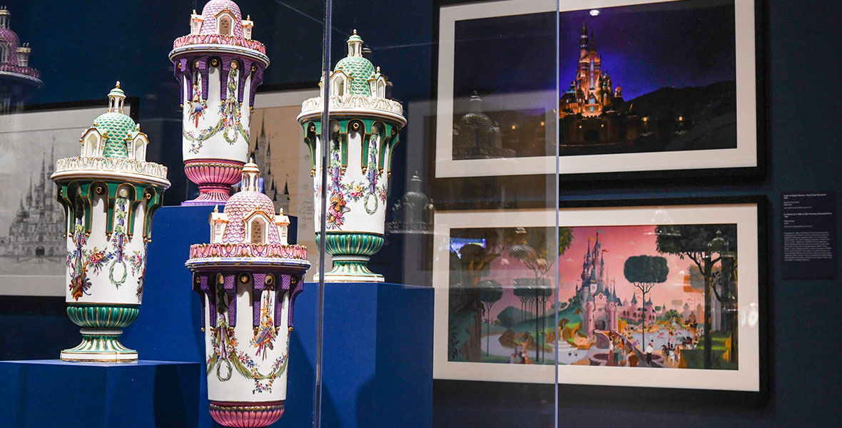 Pair of tower vases attributed to Etienne-Maurice Falconet and Sèvres Manufactory is seen in front of a print of concept art by Frank Armitage for Le Chateau de la Belle au Bois Dormant, the castle in Disneyland Paris.