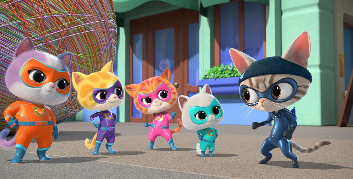 In the SuperKitties episode “The Great Yarn Caper,” Buddy, Sparks, Ginny, Bitsy, and Cat Burglar—five cats wearing superhero costumes—stand on the sidewalk. Behind them is a rainbow wall of yarn and a turquoise wall with blue and brown doors.