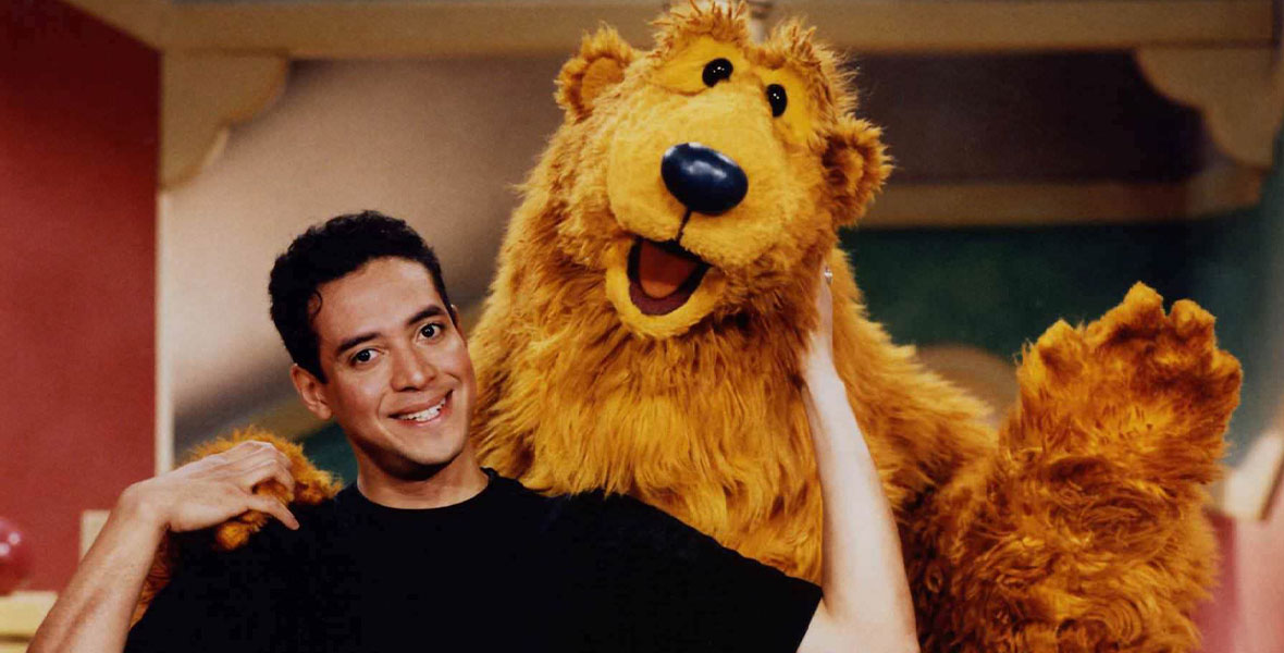 Noel MacNeal smiles and poses with Bear on the set of Bear in the Big Blue House