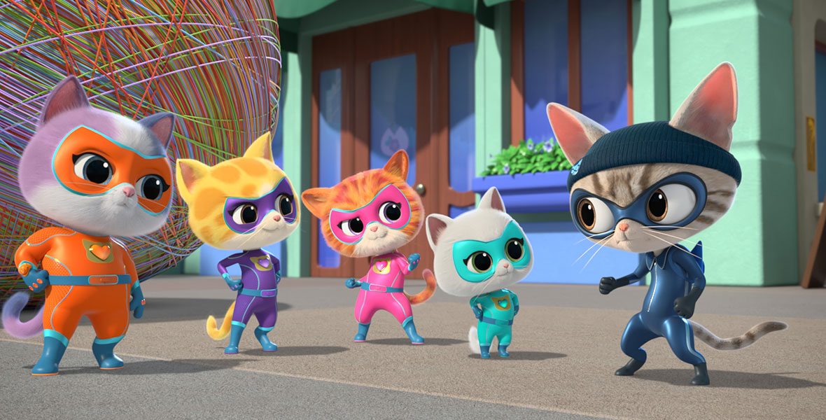 In a scene from animated series SuperKitties, four kittens wear colorful superhero suits and masks and stand side by side. The group looks at another cat wearing a blue beanie on its head, a navy mask, and a navy superhero suit. Behind the cats is an enormous ball of yarn.