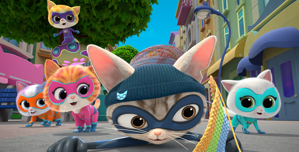 In a scene from the Disney Channel animated series SuperKitties, kittens wear colorful super hero masks and uniforms and walk down a city sidewalk.