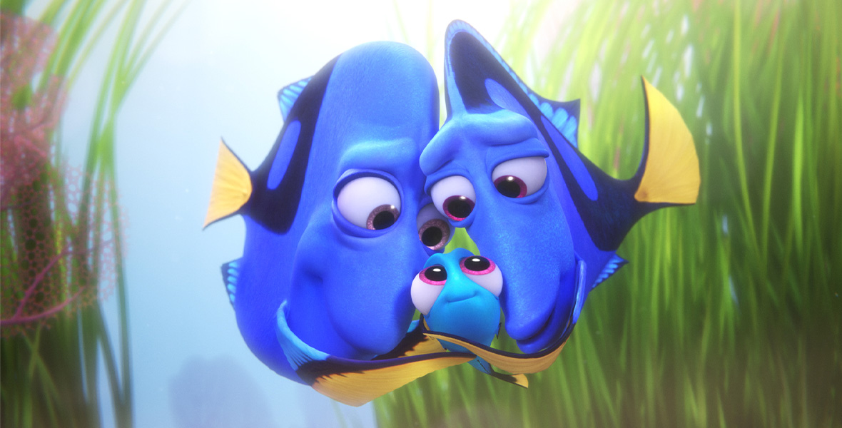 In a scene from Pixar’s Finding Dory, three Royal Blue Tang fish hug.