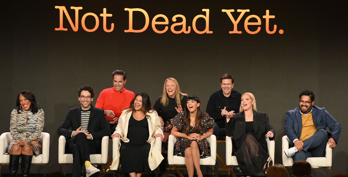 Angela E. Gibbs, Rick Glassman, David Windsor (Co-Showrunner, Executive Producer), Gina Rodriguez (Executive Producer), Casey Johnson (Co-Showrunner, Executive Producer), Hannah Simone, Dean Holland (Executive Producer), Lauren Ash, and Josh Banday sit in chairs onstage during the 2023 Winter TCA Press Tour.