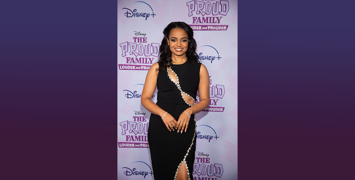 Kyla Pratt poses in front of the step and repeat for The Proud Family: Louder and Prouder Season 2.