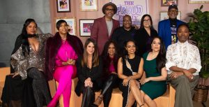 Bruce W. Smith, Calvin Brown Jr., Jan Hirota, Ralph Farquhar, Paula Jai Parker, EJ Johnson, Soleil Moon Frye, Karen Malina White, Kyla Pratt, Alisa Reyes, and Billy Porter pose for a group photo in front of a backdrop themed to The Proud Family: Louder and Prouder.