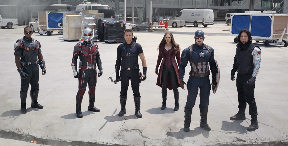 In a scene from Captain America: Civil Wear, a group of Super Heroes—from left to right, The Falcon, Ant-Man, Hawkeye, Wanda Maximoff, Captain America, and The Winter Soldier—stand on an airport tarmac. A deep crevice has formed in the cement in front of the Super Heroes. No one is smiling. Their hands are at their sides.