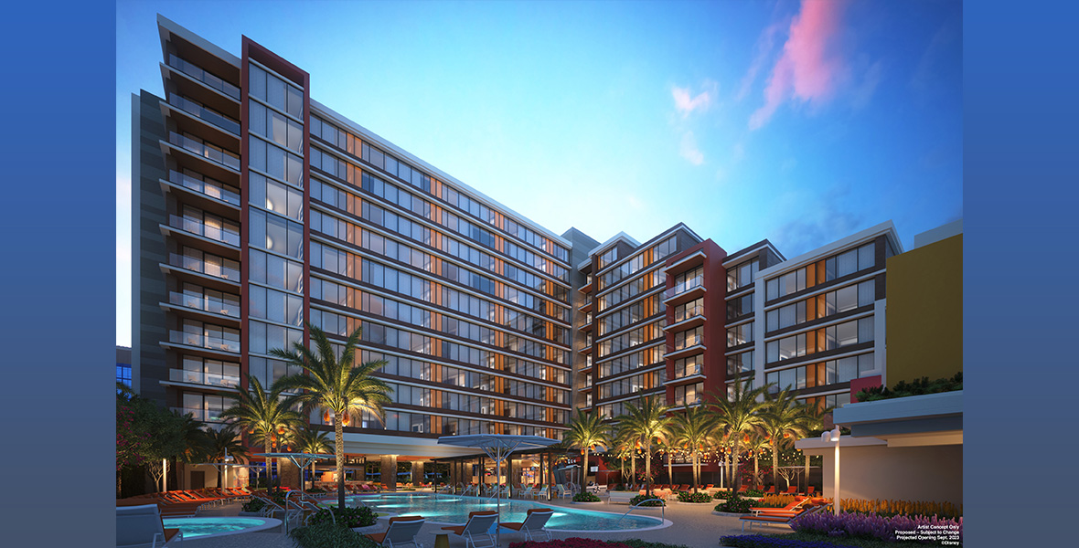 Concept art for the new fourth tower of the Disneyland Hotel is seen at dusk. A pool is seen in the front, surrounded by lounge chairs and some short palm trees.