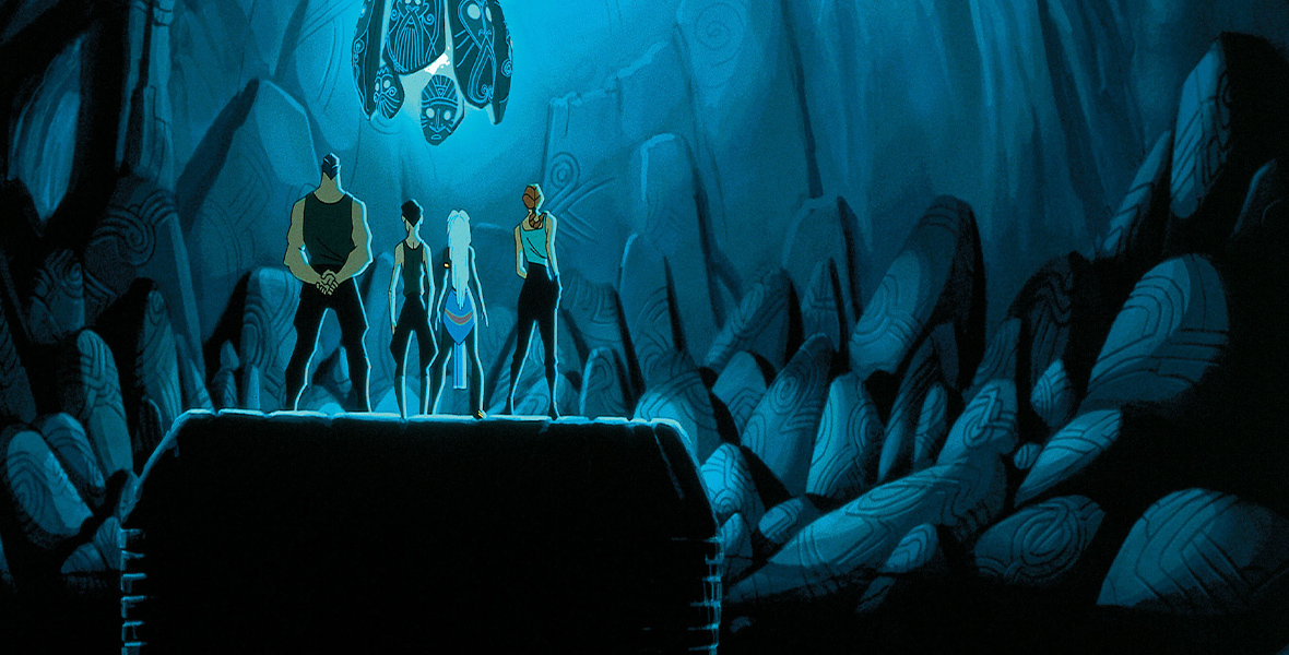 In a huge cavern, we see the backs of four people standing on a rock, Kida and Milo among them. They look up at the Heart of Atlantis, which levitates up toward the cavern’s ceiling. The glowing blue crystal is surrounded by six oblong fragments with ancient faces carved upon them. The light floods into the cavern, but the bottom half of the frame is still dark.