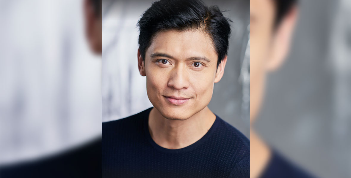 A headshot of actor Paolo Montalban, who reunites with Brandy in the upcoming Descendants: The Rise of Red. The pair were previously seen together in 1997’s The Wonderful World of Disney film Rodgers and Hammerstein’s Cinderella. In the image, Montalban has dark hair and is wearing a dark shirt.