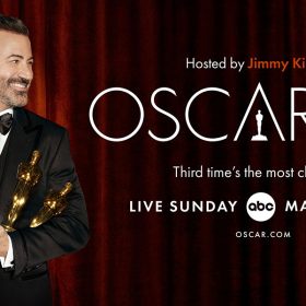 A poster for The Oscars. To the left, this year’s host, Jimmy Kimmel, wears a black suit and bowtie with three Oscar statues in his hands. He grins to the right, where text reads “Hosted by Jimmy Kimmel / Oscars 95 / Third time’s the most charming” in reference to his third time hosting.