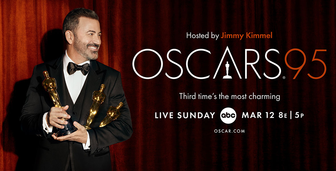 A poster for The Oscars. To the left, this year’s host, Jimmy Kimmel, wears a black suit and bowtie with three Oscar statues in his hands. He grins to the right, where text reads “Hosted by Jimmy Kimmel / Oscars 95 / Third time’s the most charming” in reference to his third time hosting.