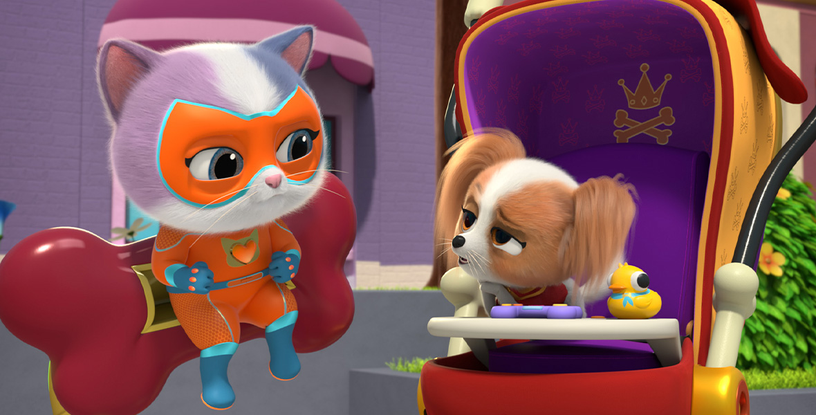In a scene from an episode of SuperKitties, a white, purple, and gray kitten uses a jetpack to talk to a small brown and white dog in a red stroller. The kitten wears an orange superhero mask, an orange jumpsuit, and blue boots.