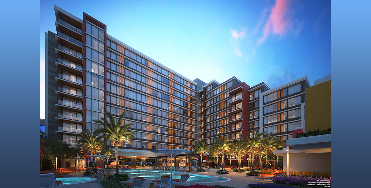 Concept art for the new fourth tower of the Disneyland Hotel is seen at dusk. A pool is seen in the front, surrounded by lounge chairs and some short palm trees.