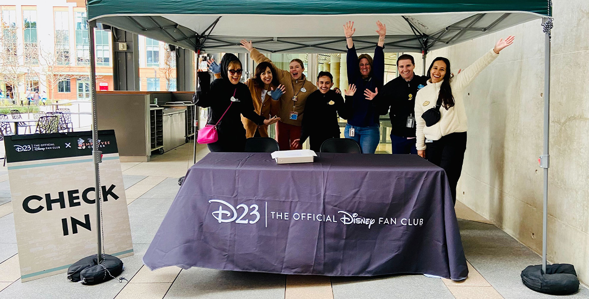 Cast members celebrate the event and eagerly await the arrival of members to begin checking them in.