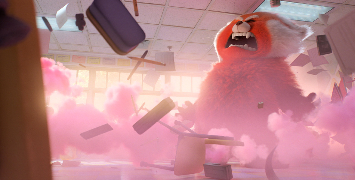 In a scene from Turning Red, a giant red panda screams in a classroom covered in red smoke.