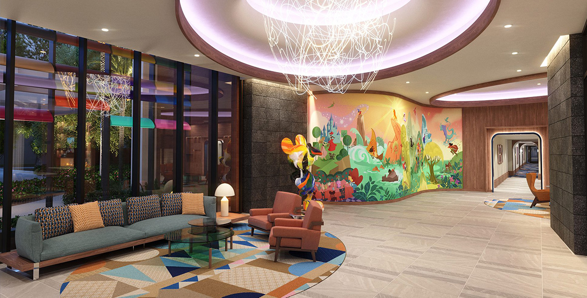 A concept artist’s image of the lobby at The Villas at Disneyland Hotel. A colorful mural by Disney Animation artist Lorelay Bové is seen towards the right, featuring characters from several Disney animated films. To the immediate left of the mural is a colorful statue of Mickey Mouse. On the left of the image is a seating area, with a couch and several chairs, next to a window. A large light fixture is seen overhead. A hallway can be seen past the mural to the far right.