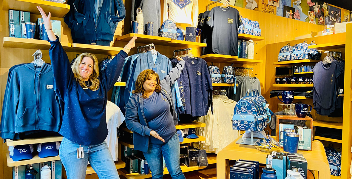 Cast members dressed in Disney gear show off the wide selection of merchandise available in the employee store.