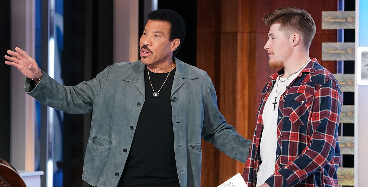 In a scene from an episode of American Idol, judge Lionel Richie stands next to contestant Colt Glover.