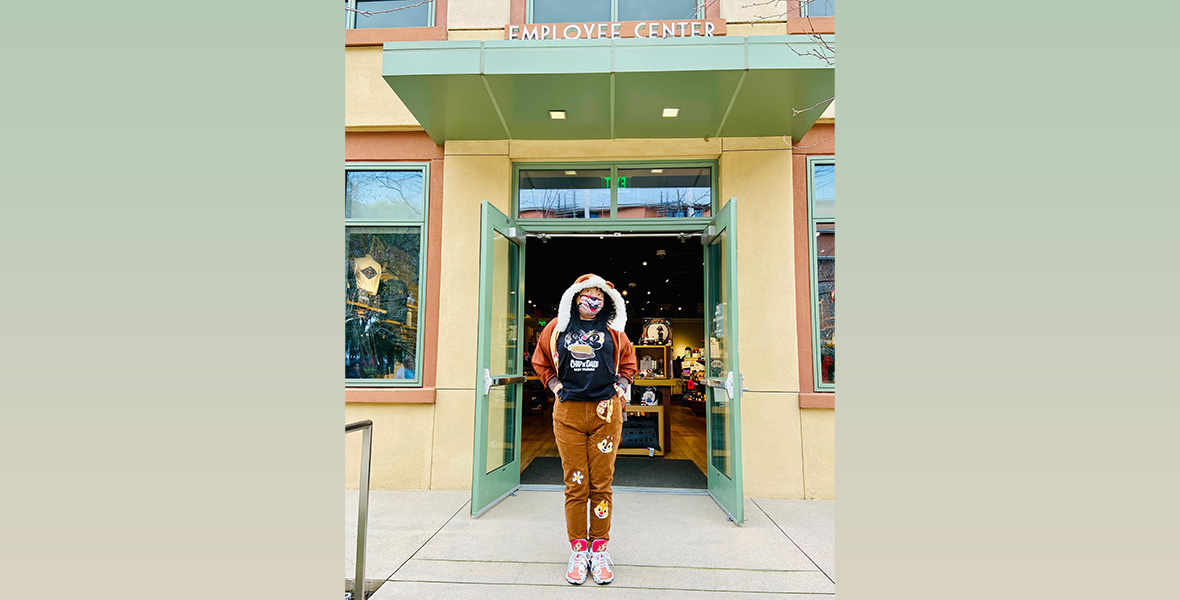 A D23 Gold Member poses in front of the employee store, dressed from head-to-toe in Chip ‘n Dale merchandise.