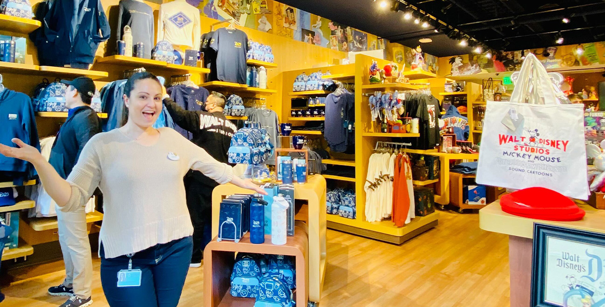 A cast member beams inside of the employee store, celebrating a successful event.
