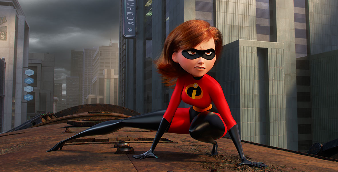 In the animated film The Incredibles 2, Elastigirl wears her classic red super suit and black mask. She braces herself atop a moving train, staring intently forward as she inspects the situation.