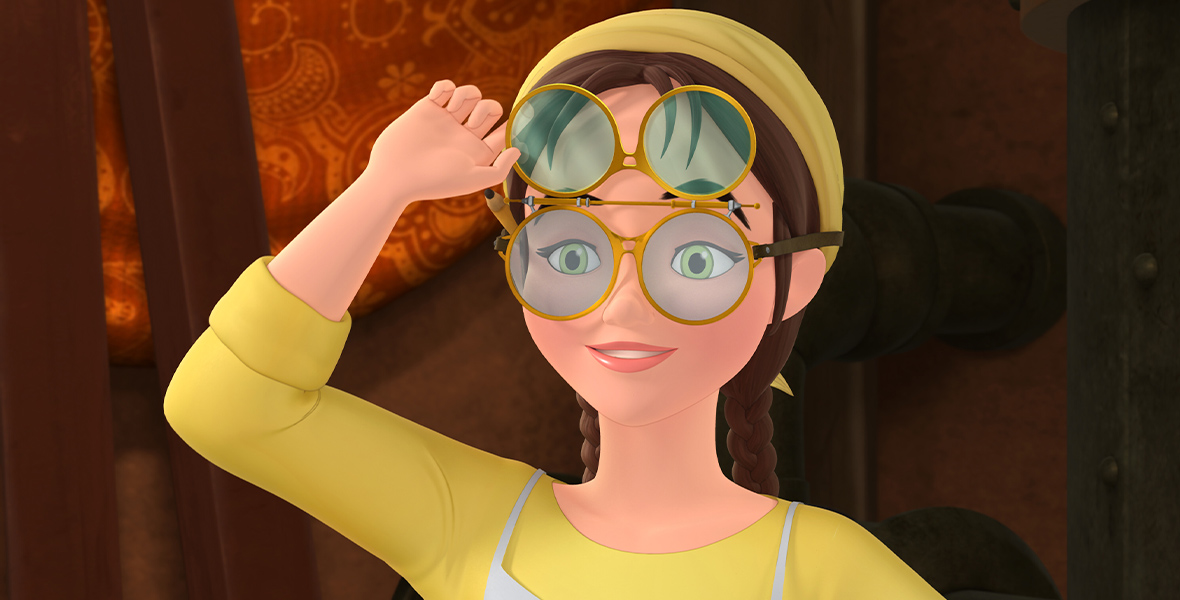 In a still from Sofia the First, a close-up of the animated Gwen, voiced by Ginnifer Goodwin—who wears a double-sided pair of round glasses. She lifts the top half of the glasses toward her forehead, and her green eyes peer through the bottom half. Her brown hair is tied back into two braids with a yellow hairband, and she wears a yellow dress and white apron.