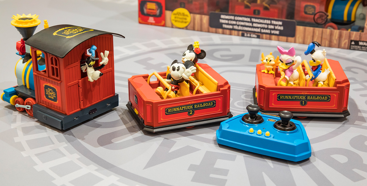 A photo of the Mickey & Minnie’s Runaway Railway Remote Control Trackless Train, modeled after the attraction. Figures of Mickey Mouse and Minnie Mouse sit in the front car while Donald and Daisy reside in the second. Goofy sticks his head out of the locomotive.