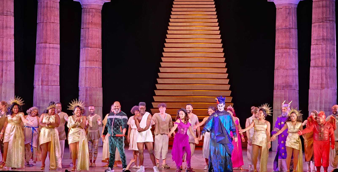 The Hercules cast stands onstage with the musical director, as audiences applaud them for their amazing performance.
