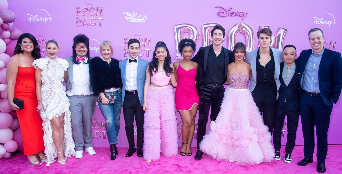 The cast of Prom Pact poses for a photo on the pink carpet at the premiere.