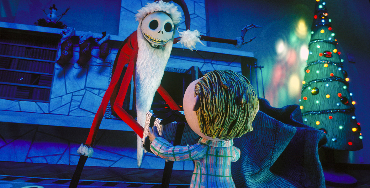 In the stop-motion animated film Tim Burton’s The Nightmare Before Christmas, the towering Jack Skellington is wearing a Santa Claus costume. He looms over a child in a Christmas-decorated home, offering him a present from his sack.