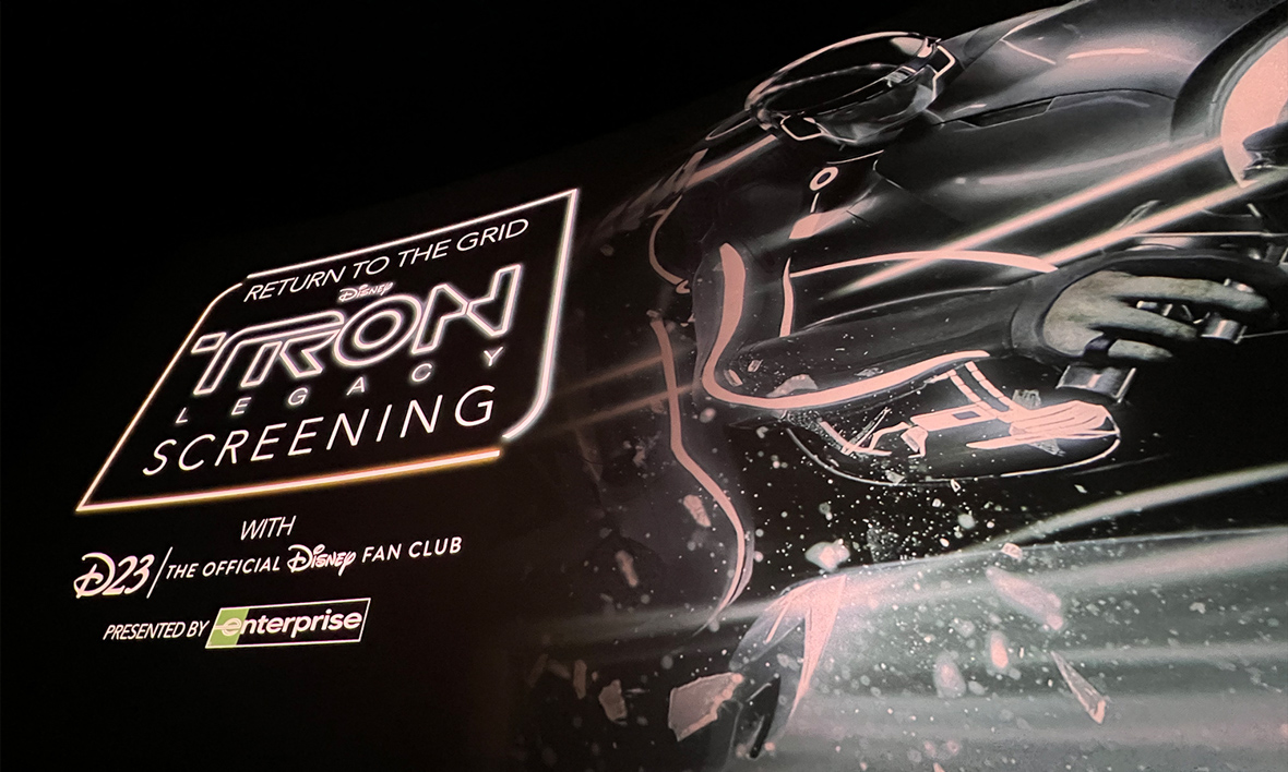 Takes TRON to the big screen, featuring a title slide with stills from the film.
