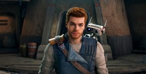 Cal Kestis casts the camera a serious look, while BD-1 is perched on his back and peering over his left shoulder. They stand in front of the Cantina on Koboh.