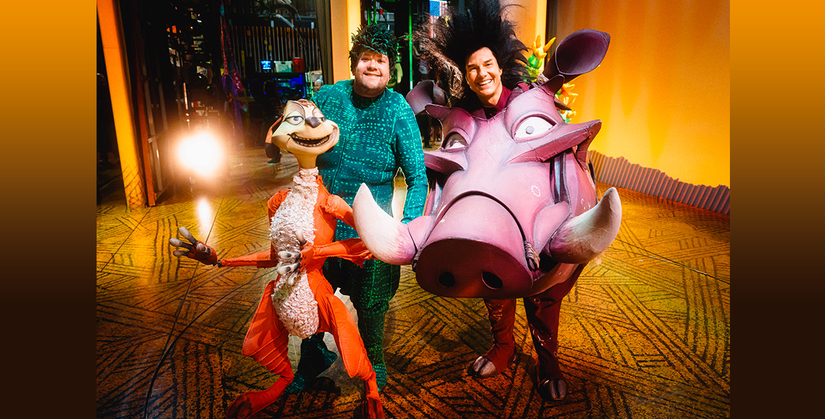 An image of James Corden (left) holding a puppet of Timon, and Tom Cruise (right) dressed as Pumbaa, from Disney’s The Lion King—in a segment from The Last Last Late Late Show with James Corden Carpool Karaoke Special. They’re smiling at the camera while standing on the stage at the Hollywood Pantages Theatre in Los Angeles, CA.