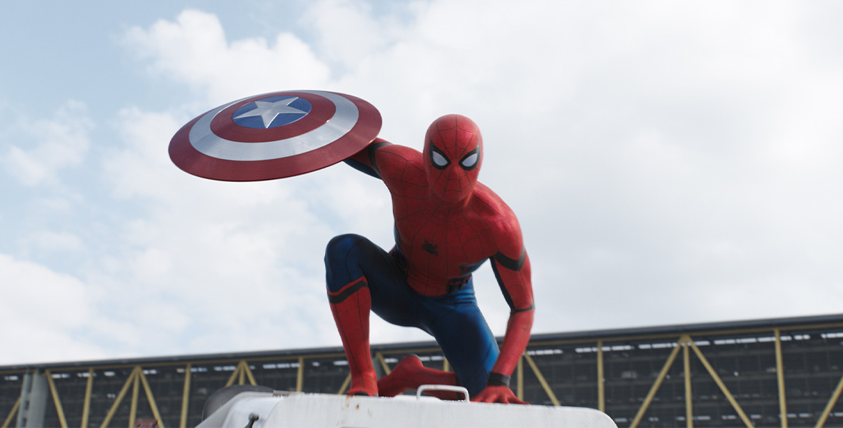 In a scene from Captain America: Civil War, Spider-Man poses on top of building and holds Captain America’s shield.