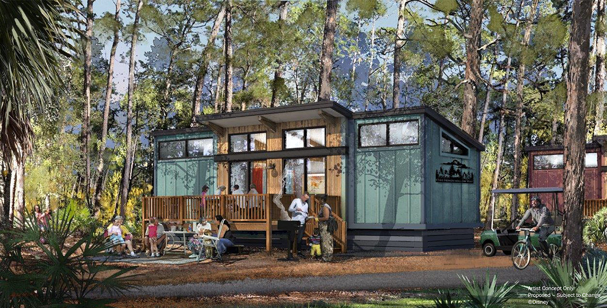 In concept art for The Cabins at Disney’s Fort Wilderness Resort – A Disney Vacation Club Resort, one of the resort’s refreshed cabins is seen, surrounded by trees and wilderness. A family is barbecuing and seated at several tables: one on the ground outside the cabin and one on the cabin’s porch. The cabin itself is square with an angular roof.
