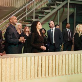 In a scene from an episode of General Hospital, actors Robert Gossett, Donnell Turner, Brook Kerr, Michael Easton, Kristina Wagner, Brooklyn Rae Silzer, and Tristan Rogers stand on a rooftop and look at the sky.