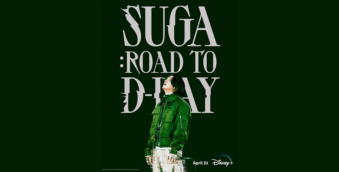 The promotional poster for Suga: Road to D-Day, coming soon to Disney+, features BTS star SUGA wearing a bright-green jacket as he stares up towards the sky. He’s set against a darker-green background, as well as the words “SUGA: Road to D-Day” in light gray.