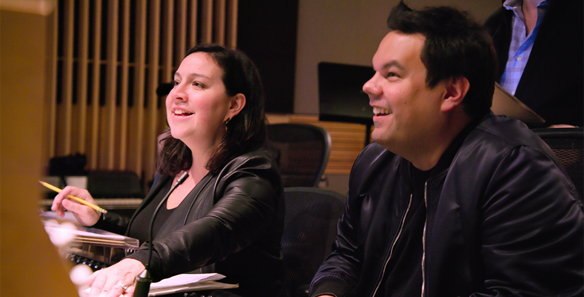 Kristen Anderson-Lopez and Robert Lopez smile in the recording studio.