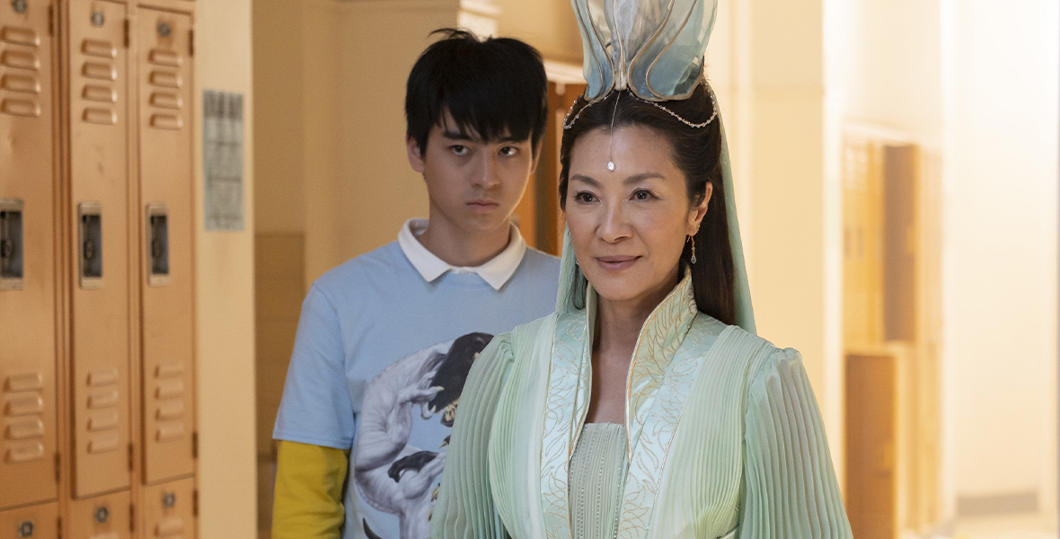 In a still from American Born Chinese, Wei-Chun (Jim Liu) and Guanyin (Michelle Yeoh) stand in front of lockers.