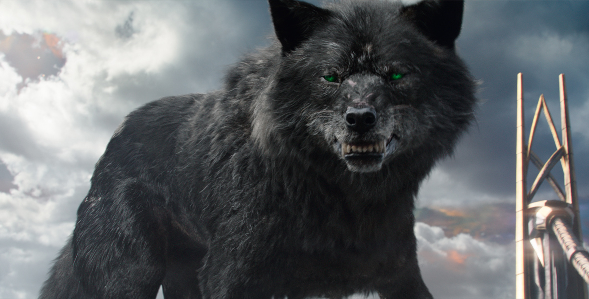 Fenris, a large black wolf with green eyes, bares her teeth at something offscreen while a storm brews behind her.