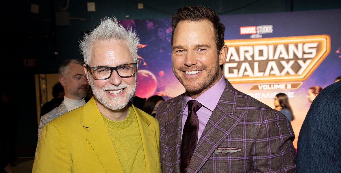 Director James Gunn (left) and actor Chris Pratt (right) smile on the purple carpet during the Guardians of the Galaxy Vol. 3 world premiere at the Dolby Theatre.