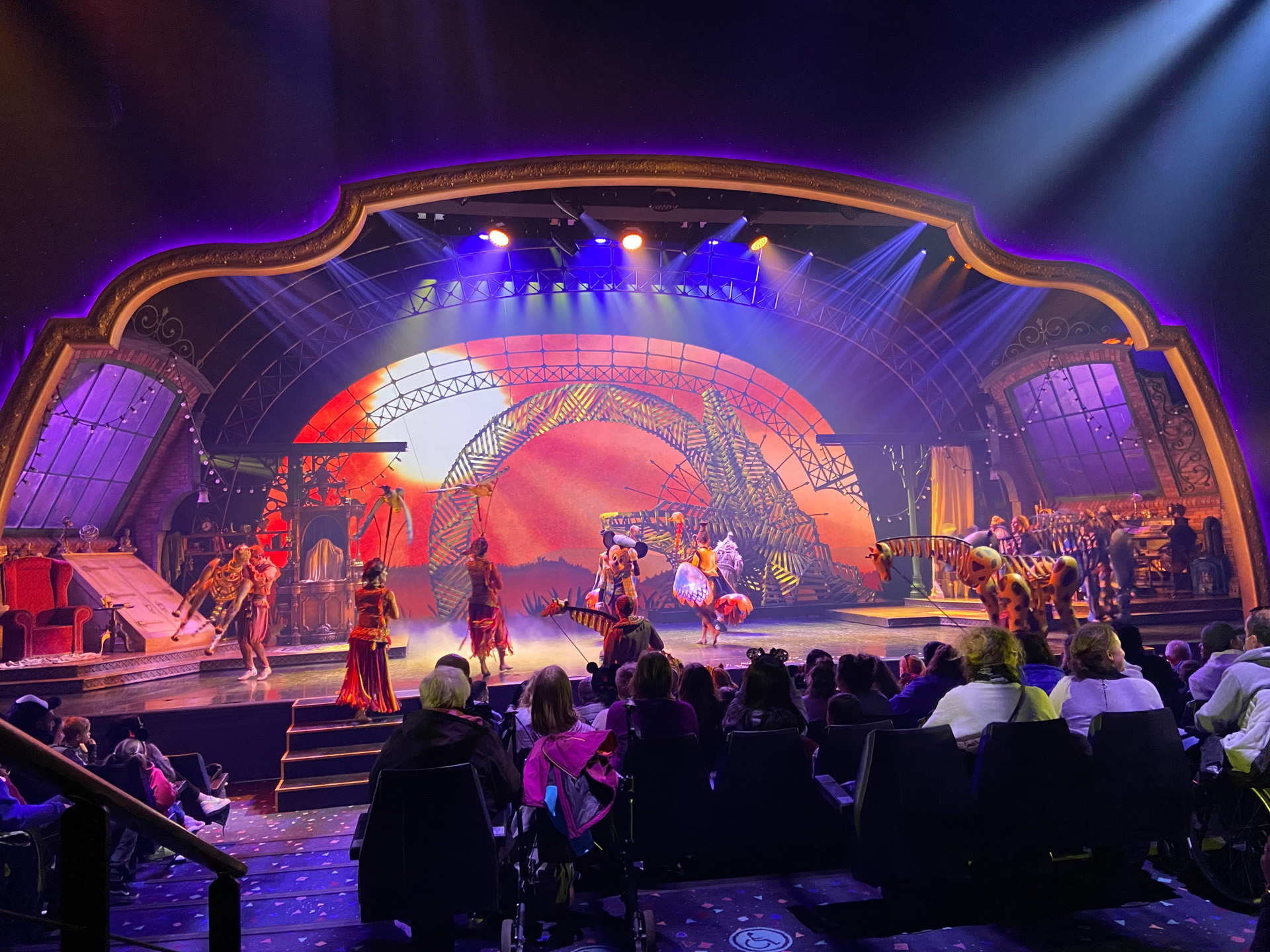 D23 Gold Members sit in their premium seats in awe at the amazing Mickey and the Magician show being put on in front of them.