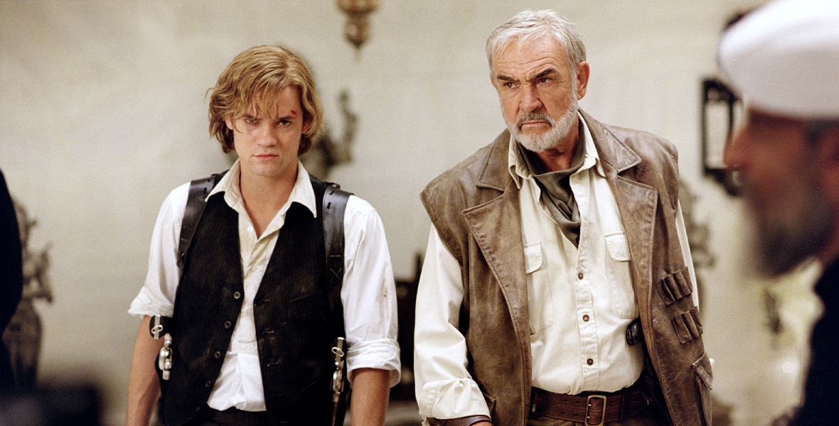 In a scene from The League of Extraordinary Gentlemen, actors Shane West as Sawyer and Sean Connery as Allan Quatermain stand side by side